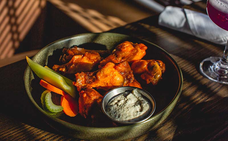 Irresistible wings at Clever Coyote, where classic flavors collide with a 90s-inspired twist.